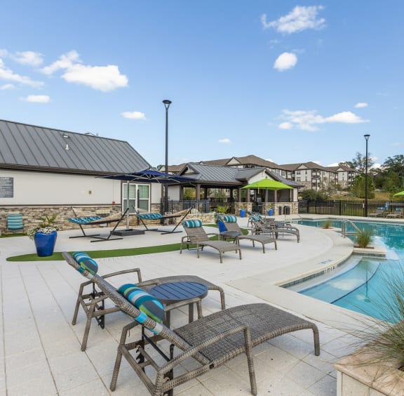 Poolside lounge chairs and hammocks at Evergreen at Southwood in Tallahassee, FL