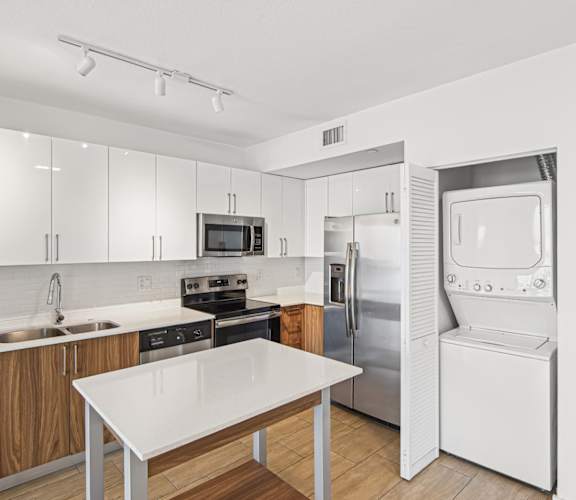 Twenty3 floor plan kitchen with table and stacked washer and dryer at Twenty2 West luxury apartments in Miami, FL