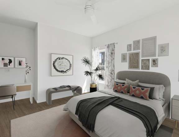 A bedroom with a large bed and a bench.