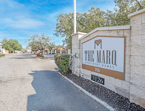 The Marq Apartment Homes sign is on a stone wall at The Marq apartments in Shreveport, LA