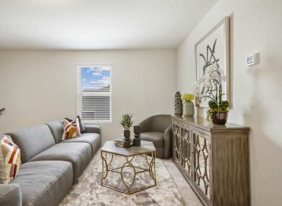 a living room with a gray couch and a coffee table
