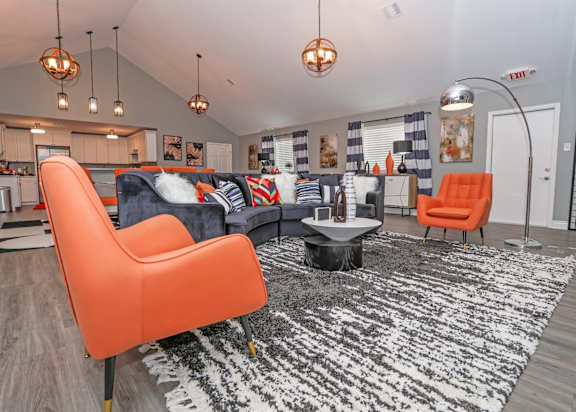 Vibrant chairs surround a table in a modern clubhouse at Orleans Square in Shreveport, LA