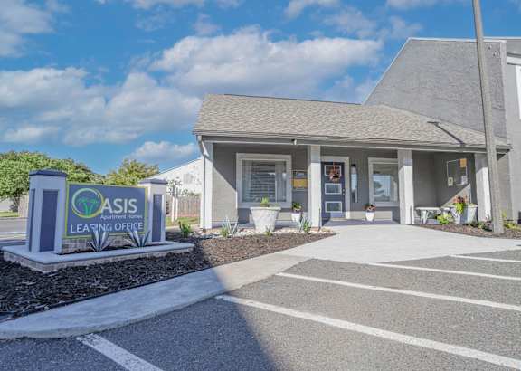 Leasing office entrance with property signage that says Oasis Leasing Office at The Oasis apartments in Bossier City, LA