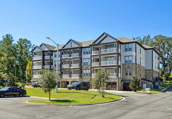 Our beautiful apartment buildings with lush landscaping along the roads at Evergreen at Southwood in Tallahassee, FL