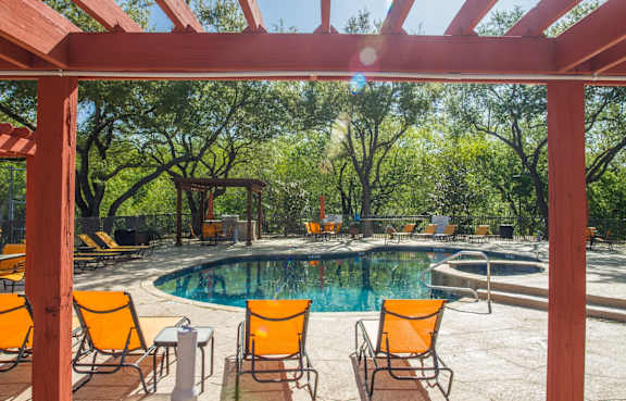a backyard with a barbecue grill and a table and chairs