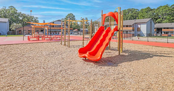 A playground with a red slide at The Marq apartments in Shreveport, LA