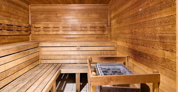a wooden sauna with two benches and a table at Columbus Apartments in Columbus, Georgia, GA