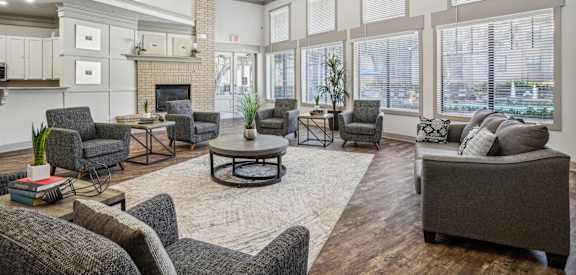 a living room with couches and chairs