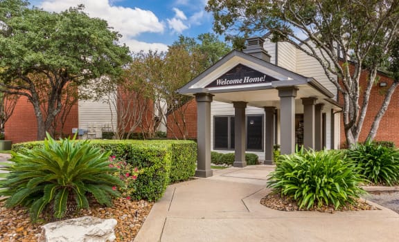 Entrance to Leasing Center, Exterior, at Hunters Chase Apartments in Austin, Texas