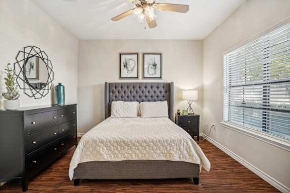 Comfortable bedroom with neutral decor and ample natural light at Southwestern Medical Park apartments in Dallas, TX