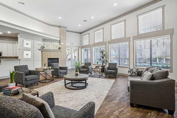 a living room with couches and chairs