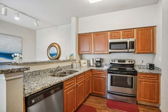 a kitchen with granite counter tops and stainless steel appliances