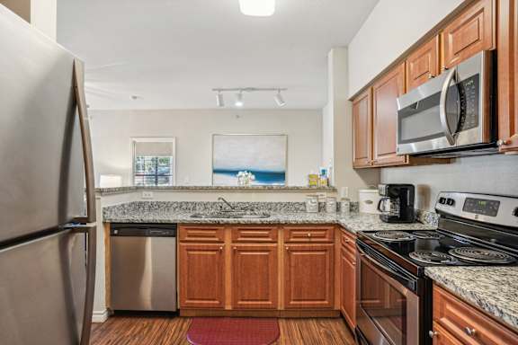 a kitchen with stainless steel appliances and granite counter tops