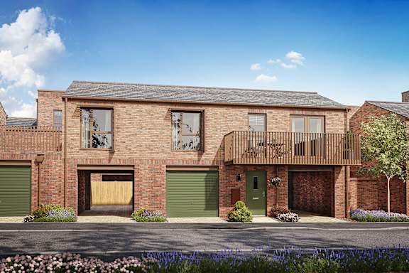 A modern brick house with a green door and a balcony.