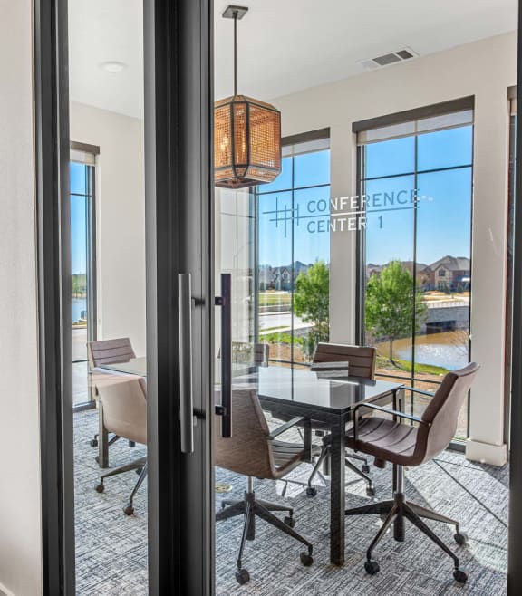 a dining room with a table and chairs next to a window