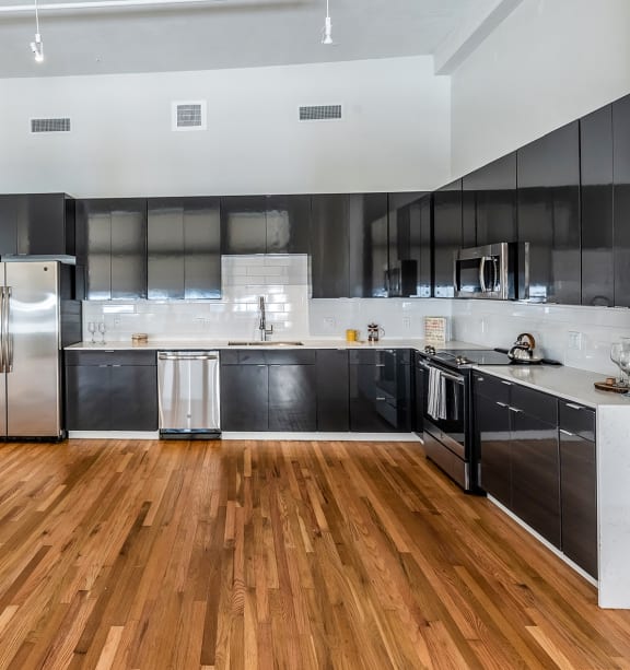 a kitchen with a stove top oven and a microwave