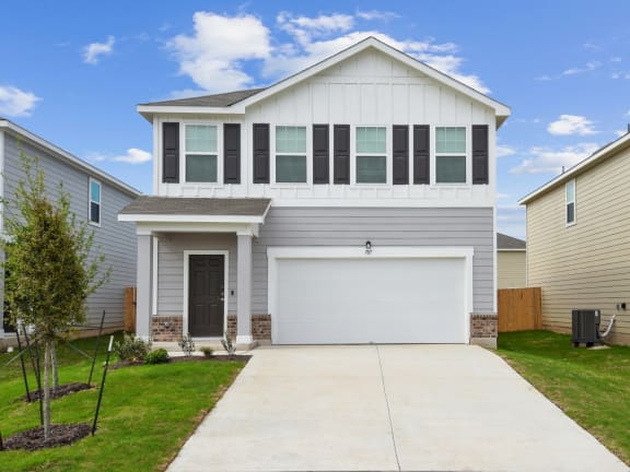 a house with a white door and gray siding at Beacon at Hymeadow, Maxwell, Texas