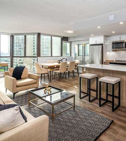A modern kitchen with a dining table and chairs.