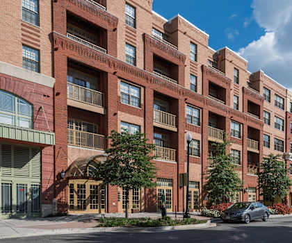 a large red brick building with a car parked outside of it