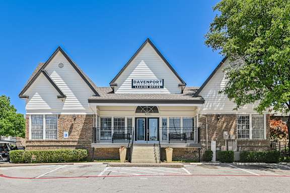 a view of the front of the bayfront apartments building with a blue sky in the background