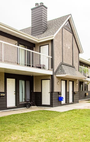 a row of houses with balconies and a yard