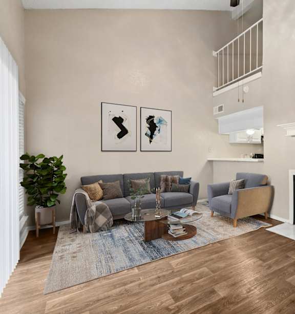 Model A2 floor plan living room with a couch a chair and view of the kitchen Noel on The Parkway in Dallas, TX