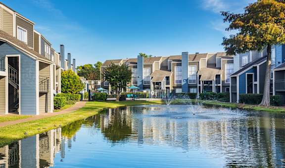 Building Exteriors and Pond View at Park at Woodlake Apartments in Houston, Texas