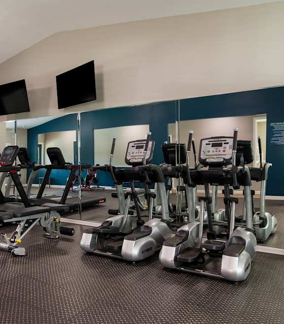 Fitness Center with cardio equipment and flat screen televisions at Dunwoody Pointe at Sandy Springs, GA