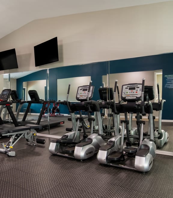 Fitness Center with cardio equipment and flat screen televisions at Dunwoody Pointe at Sandy Springs, GA