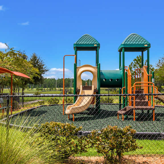 A playground with a jungle gym and slides at Oakleaf Plantation in Jacksonville, FL