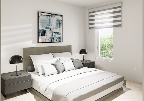 a white bedroom with a large bed and a window