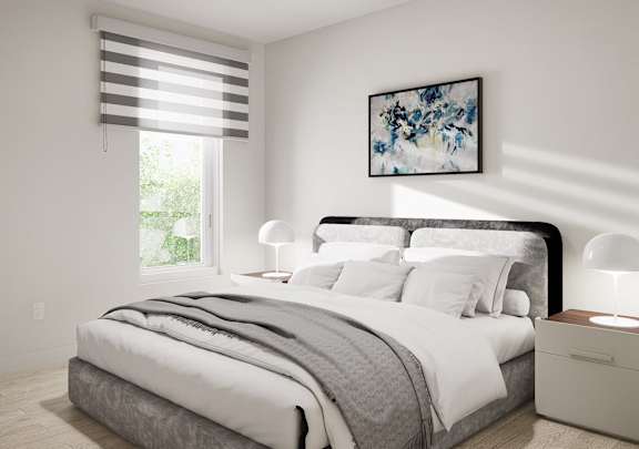 a bedroom with a bed and a painting on the wall