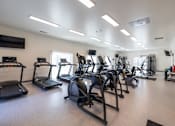 Thumbnail 9 of 9 - A gym with treadmills, elliptical machines, and other exercise equipment.