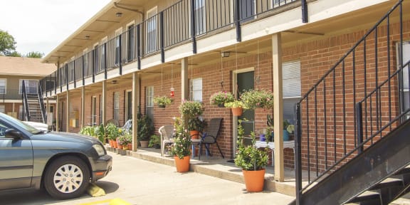 Building Exterior with Potted Plants at Garden Place Apartments in Waco, Texas, TX