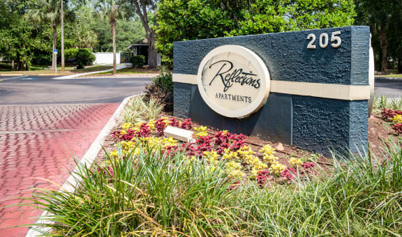 Property Entrance Sign at Reflections Apartment Homes in Gainesville, Florida, FL