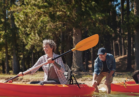 Couple on the lake in a boat at TRILLIUM LANDING, JUNEAU, AK