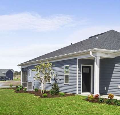 A row of houses with a blue sky in the background. at Stepping Stone at Bridgewater Apartments, South Carolina