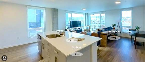 A kitchen with a white counter top and a sink. at Riverfront Everett, Washington
