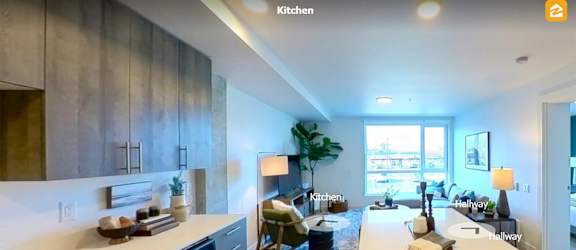 A modern kitchen with a large island and a dining area. at Riverfront Everett, Washington