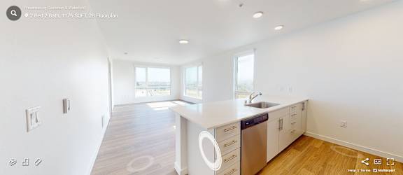 A modern kitchen with white countertops and stainless steel appliances. at Riverfront Everett, Washington