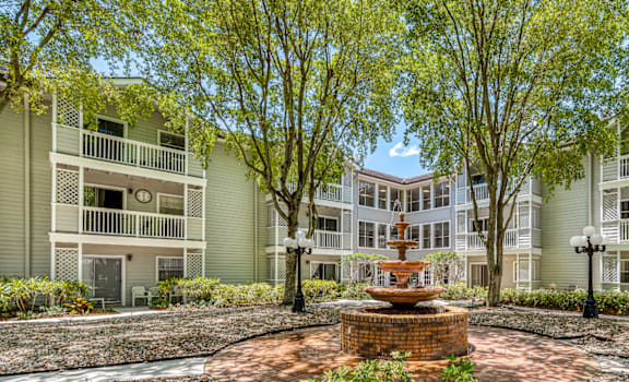 a courtyard with a fountain in the middle of an apartment building