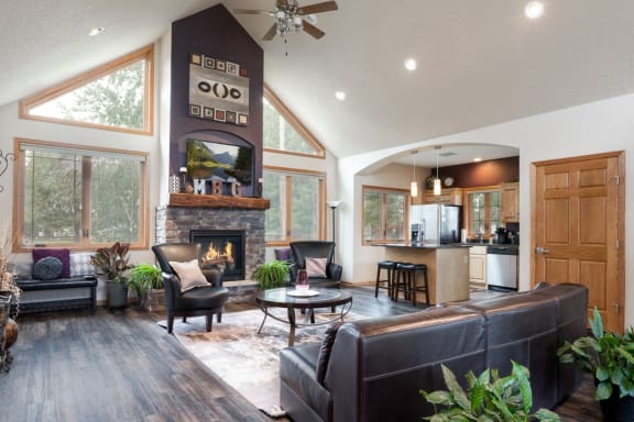the view of a living room with a fireplace and a kitchen