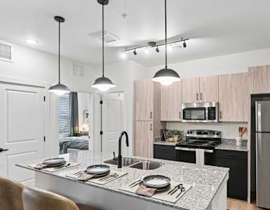 A modern kitchen with a dining table and chairs.