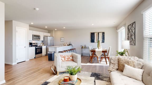 a living room with couches and chairs and a table