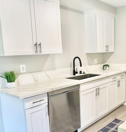a renovated kitchen with white cabinets and stainless steel appliances at BLVD Apartments LLC, California