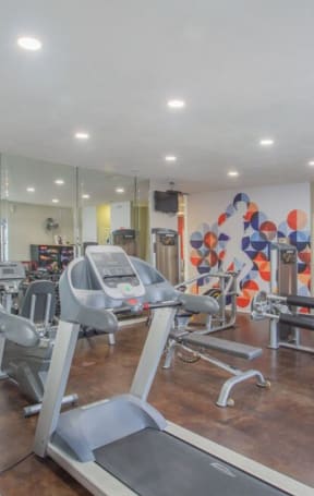 a gym with cardio equipment and mirrors in a building at Sunnyvale Crossings Apartments, LLC, Sunnyvale, CA 94087