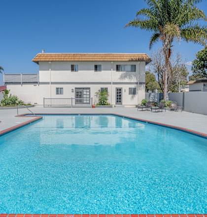 a swimming pool with a building in the background at Ocean Villas, Oxnard, CA