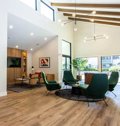 a living room with chairs and a table and a tv at Parc Medallion LLC, Union City, California