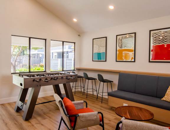 a living room with a foosball table and chairs at Parc Medallion LLC, Union City