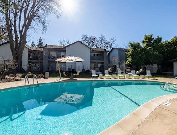 our apartments have a large pool with chairs and umbrellas at Danville Park, California